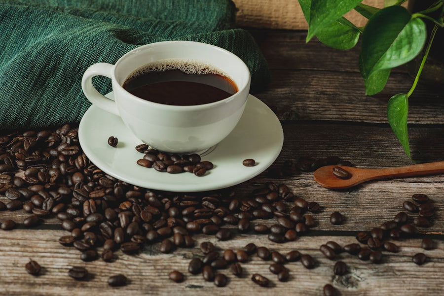 cup of coffee on coffee beans