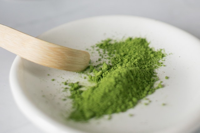 Green powder on black plate|airtight jar with green powder