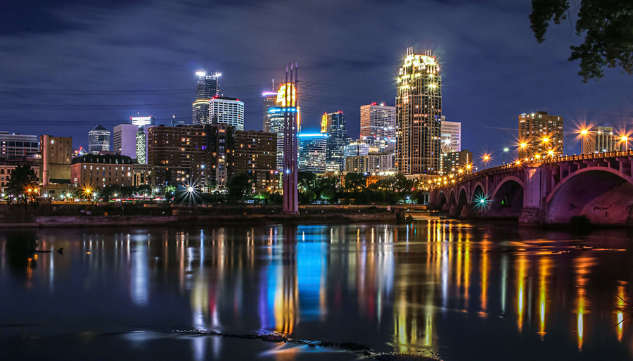 Downtown Minneapolis and the Mississippi River|woman sitting on sofa while looking at phone