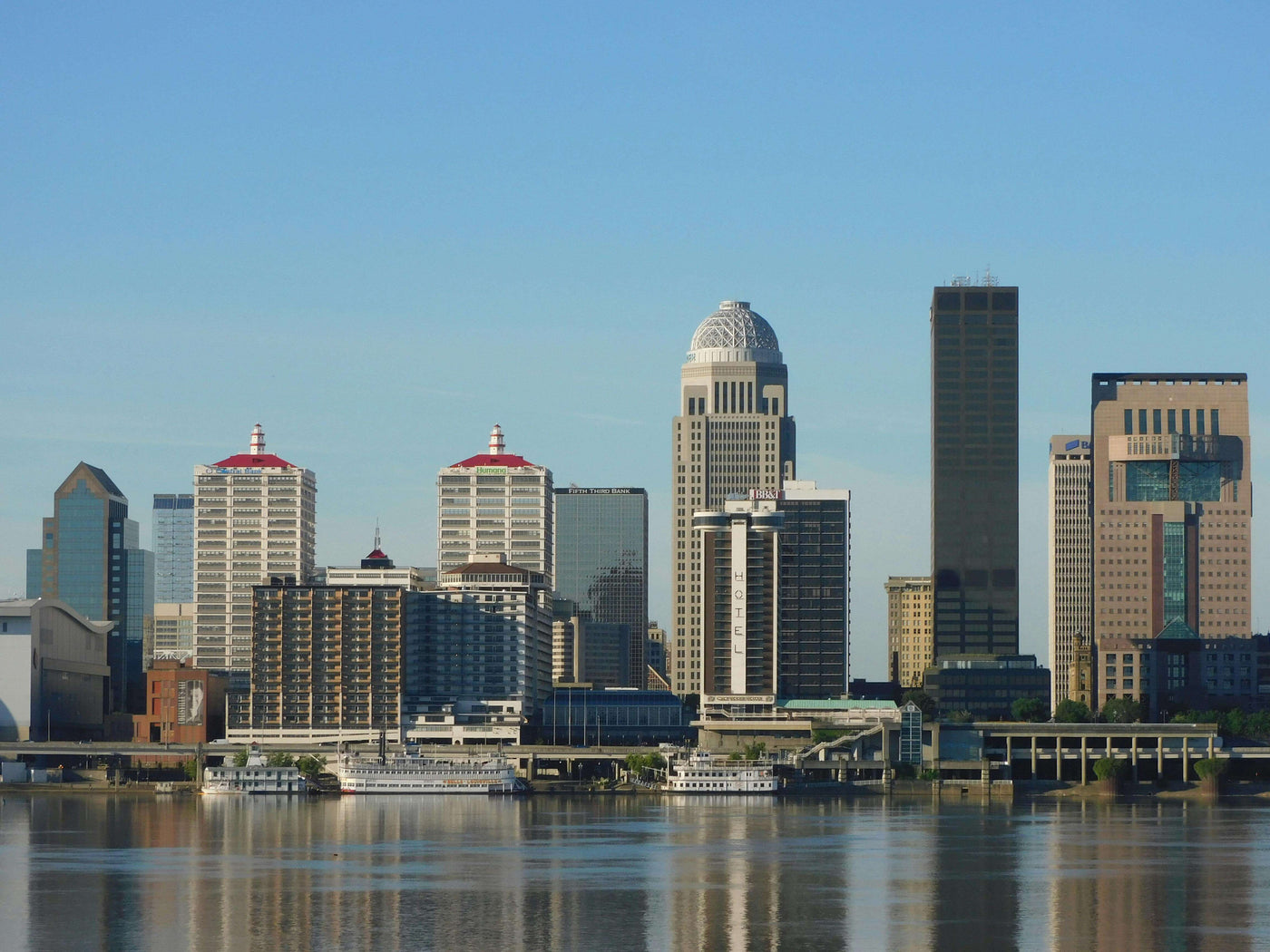 |view of Louisville, Kentucky across a river at sunset