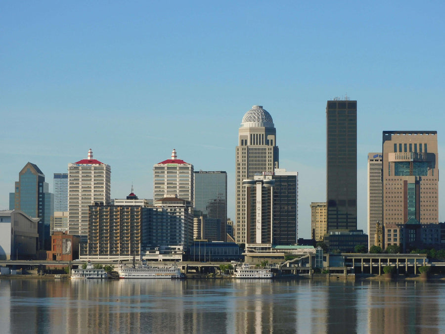 |view of Louisville, Kentucky across a river at sunset