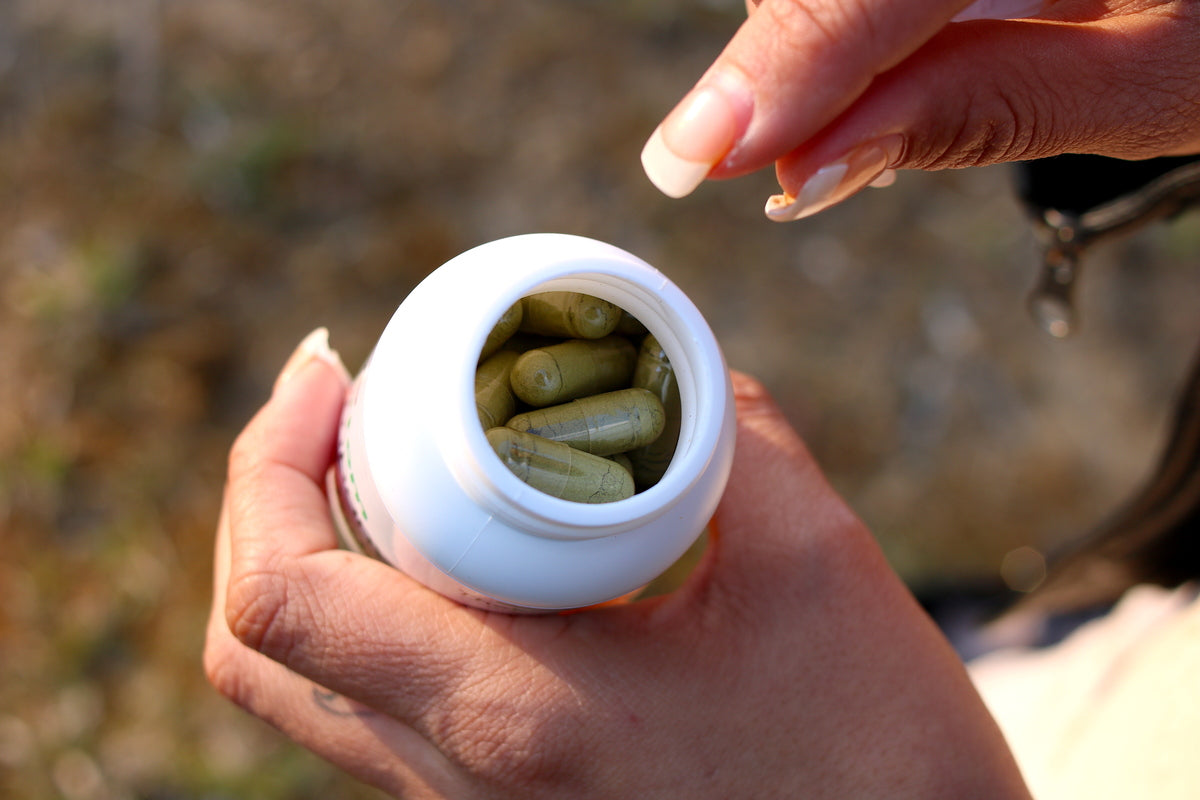  Fingers reaching for kratom capsules in Los Angeles