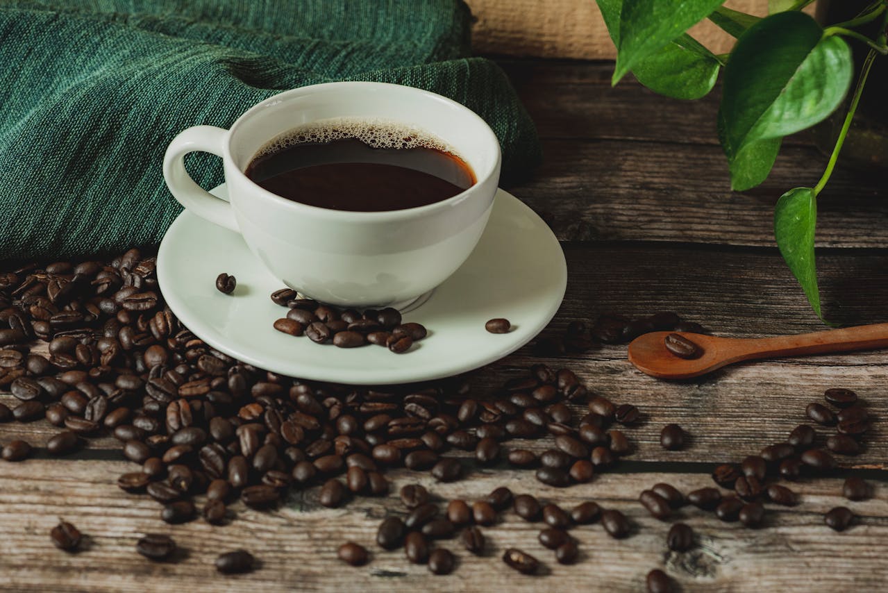 cup of coffee on coffee beans