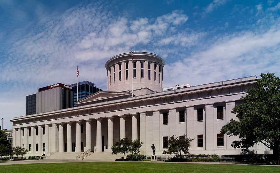The Ohio statehouse centered beneath a blue sky.|