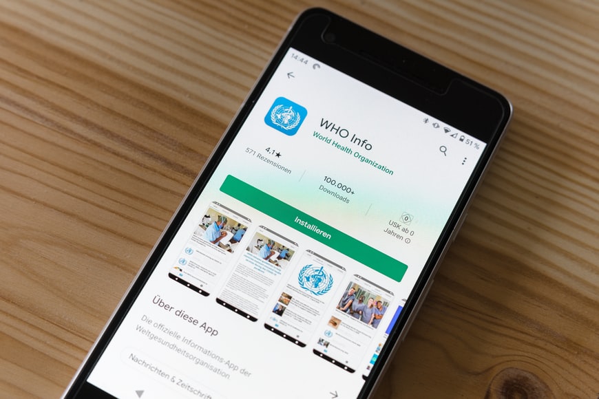 WHO info app|People Pointing at a Laptop Screen
