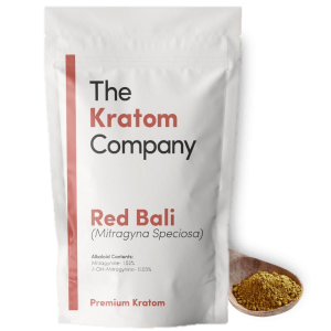 A packet of red Bali kratom powder, with some powder on a wooden vessel.