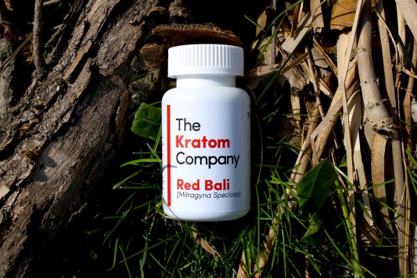Bottle of Red Bali Kratom on leaves