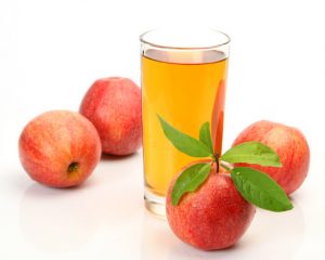 Photo of apples around apple juice