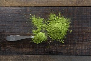 green powder on a wooden countertop