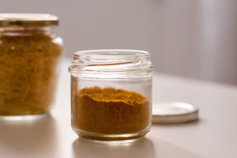 glass jar of reddish-brown powder