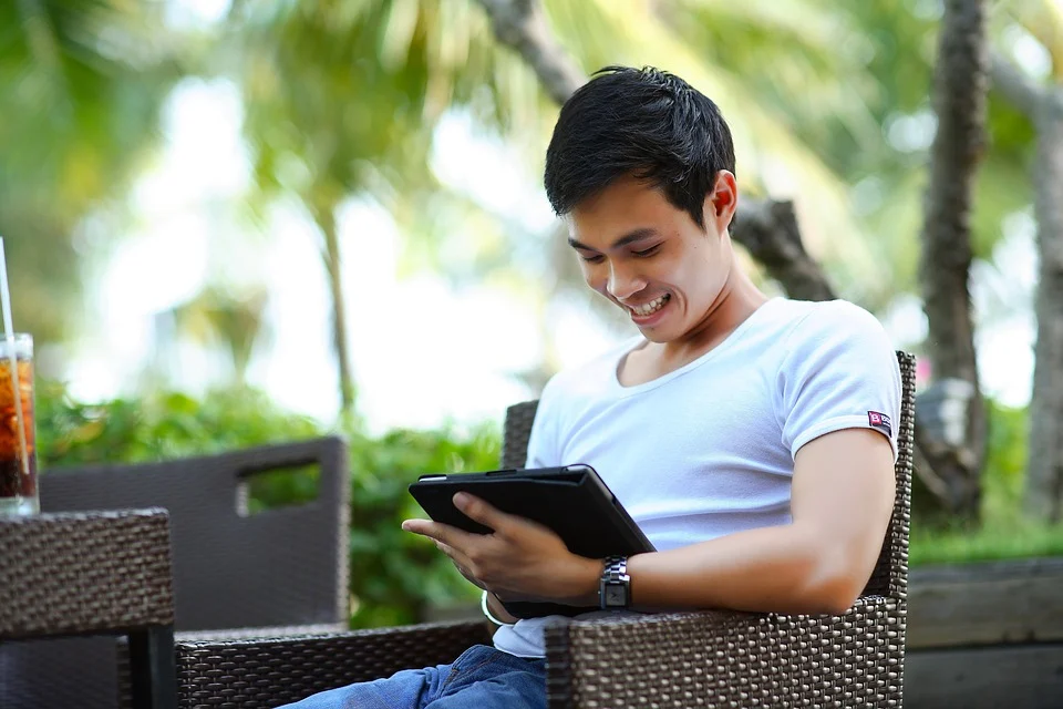 a man using a tablet outside 