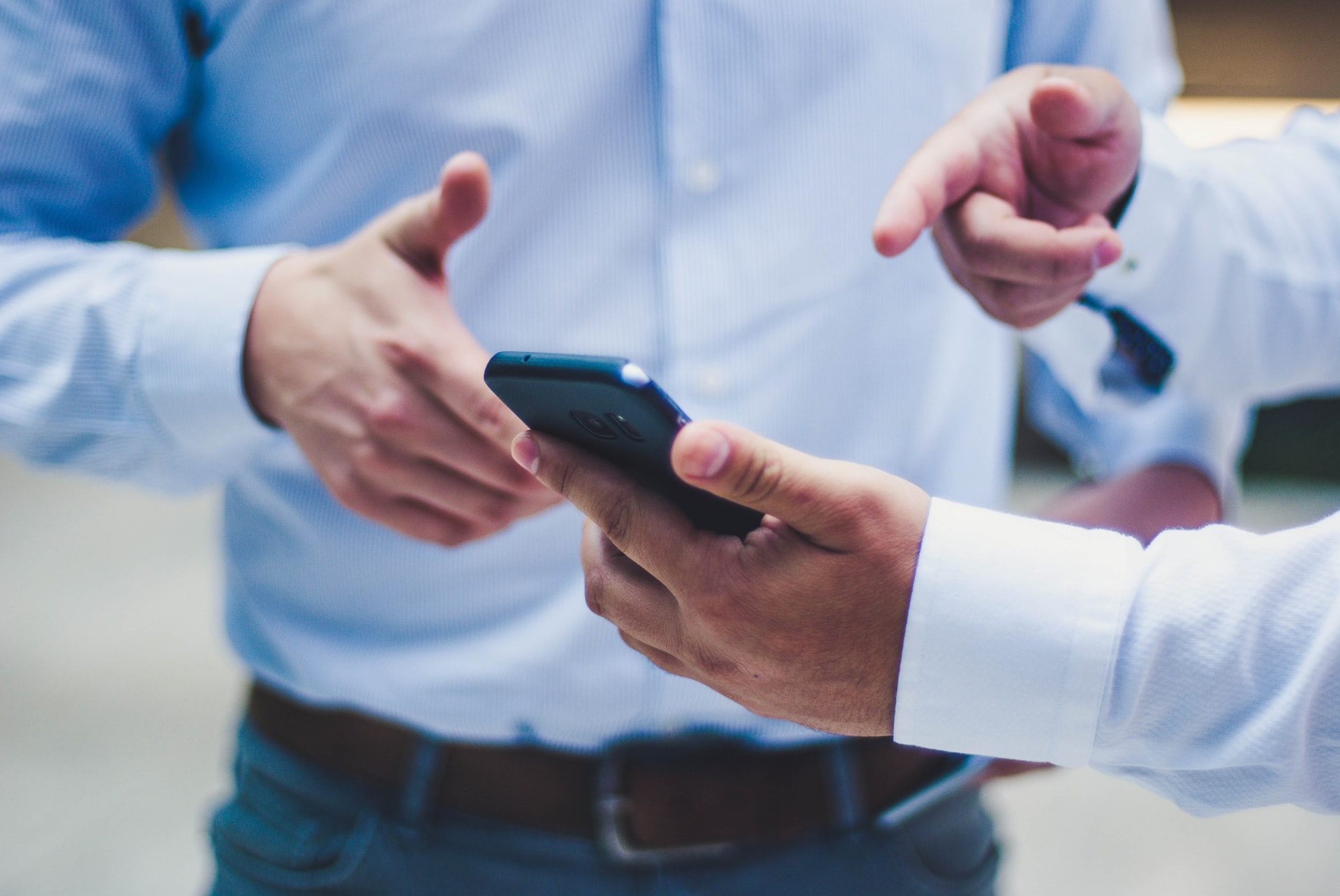 a man pointing at a smartphone