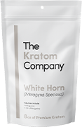 A packet of white Horn kratom powder, with some powder on a wooden vessel.