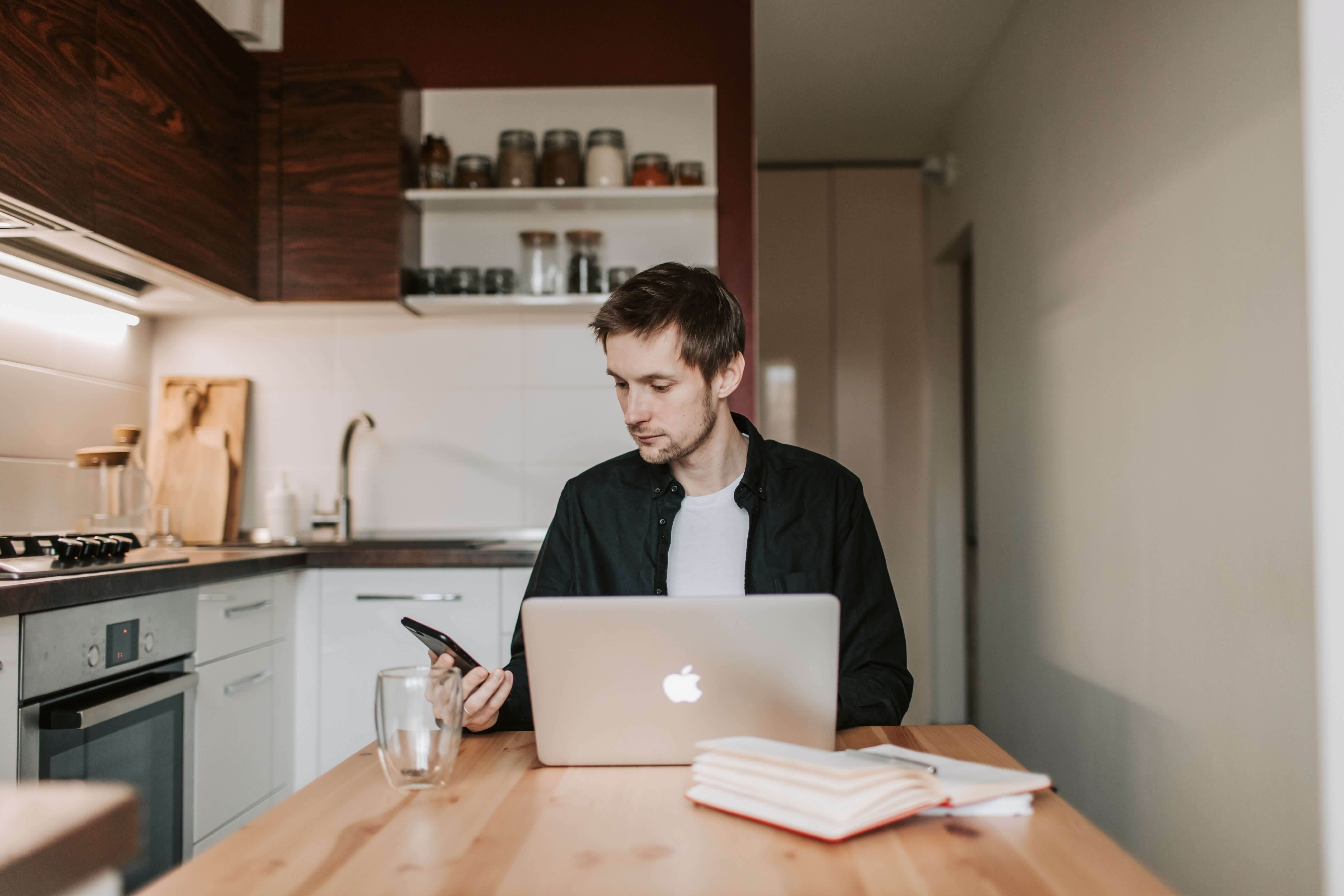 man using smartphone and laptop