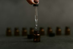 Person dropping liquid in dropper